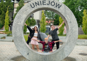 Wiktoria, Oliwia i Norbert przy fontannie w Uniejowie
